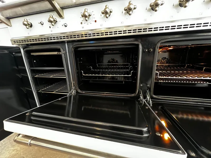 Cream range cooker's three ovens, cleaned and open